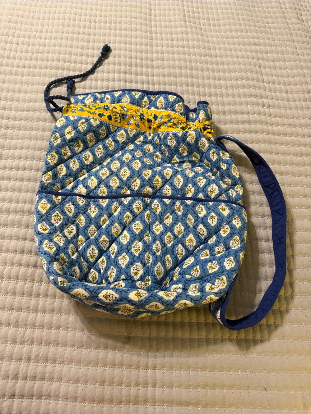 Quilted Blue Floral Drawstring Shoulder Bag with Yellow Accent